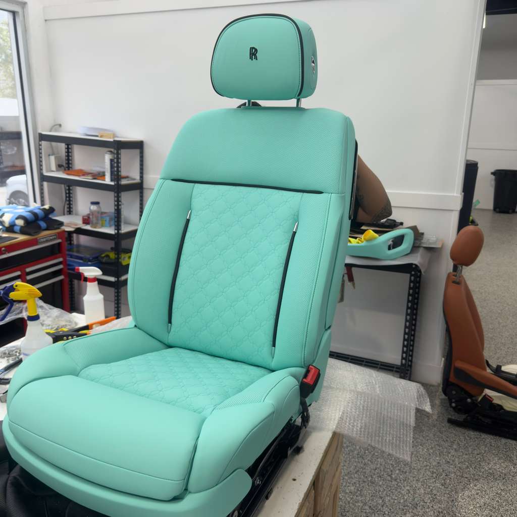 Close-up of high-end luxury red leather car seat interior restored by Motiv Auto in Pompano Beach