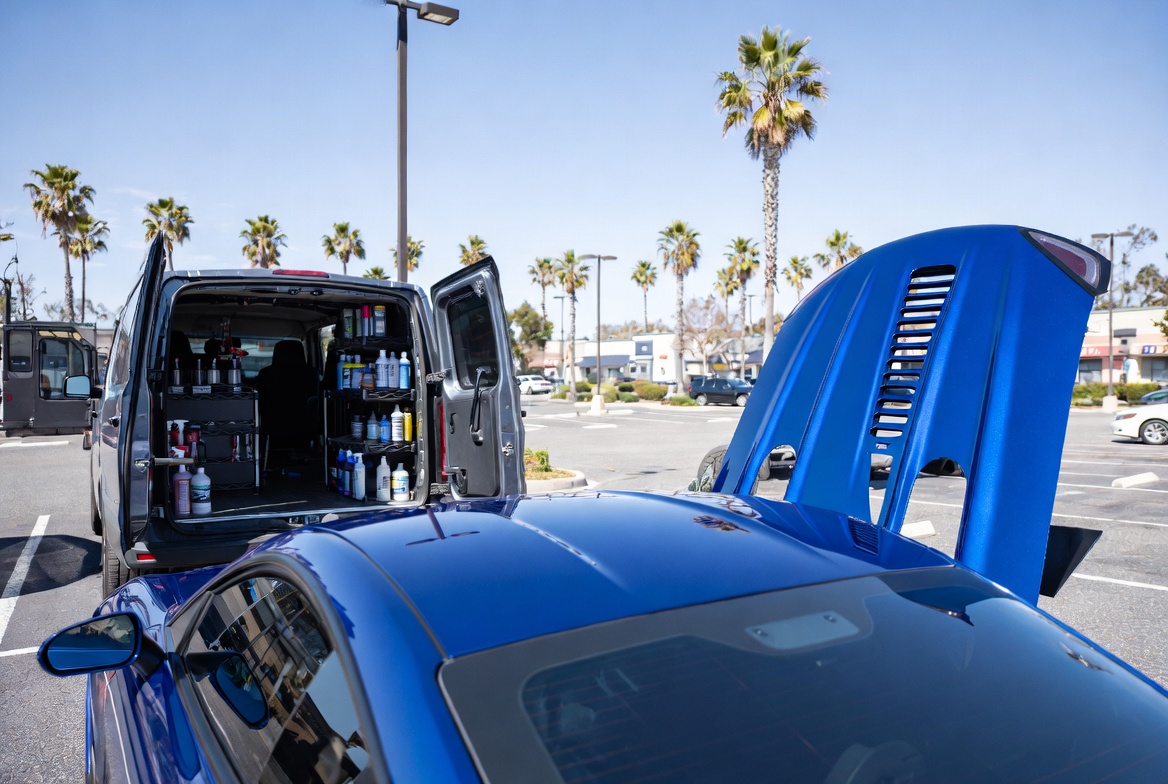 Mobile ceramic coating Pompano Beach by Motiv Auto - wide shot of professional mobile detailing setup in natural outdoor setting